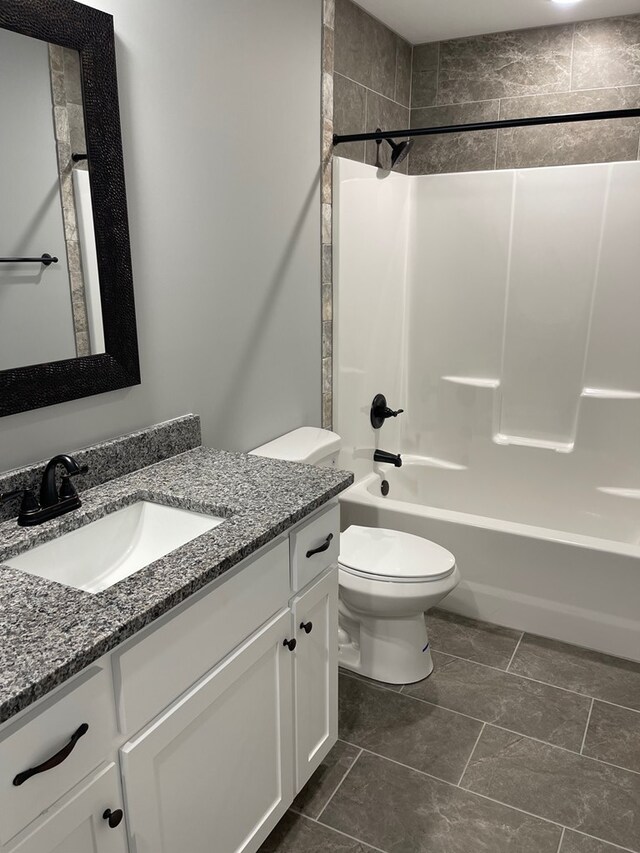 bathroom featuring toilet, vanity, and shower / washtub combination