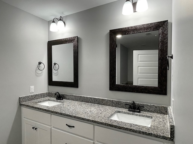 bathroom featuring a sink and double vanity