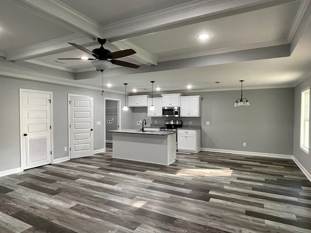 kitchen featuring ornamental molding, dark wood-type flooring, white cabinets, hanging light fixtures, and an island with sink