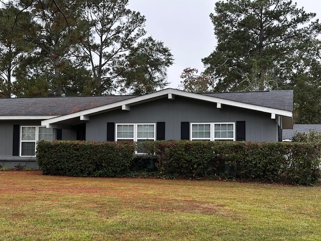 view of side of home featuring a yard