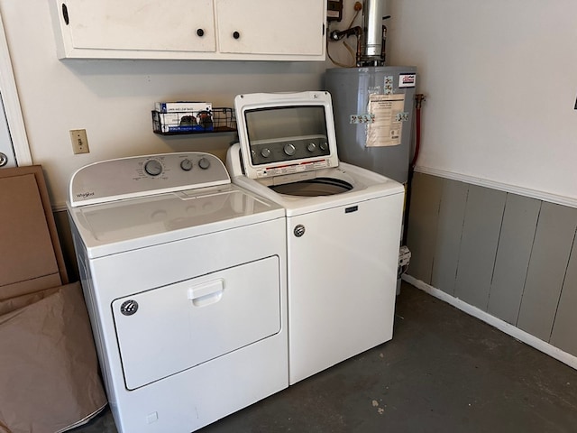 washroom with water heater, cabinets, and washer and dryer