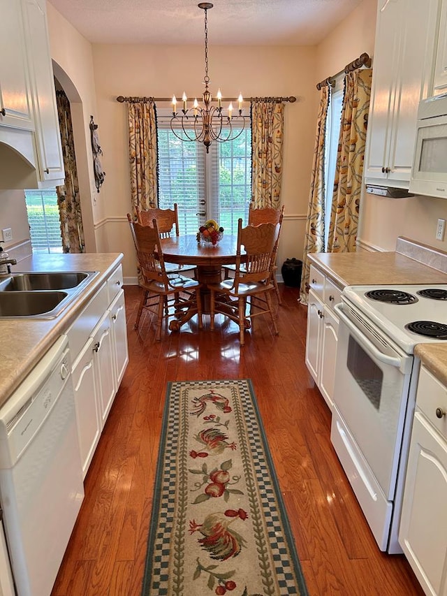 210 Petersburg Ct, Dothan, AL 36301 - kitchen featuring arched walkways, white cabinets, a chandelier, and white appliances