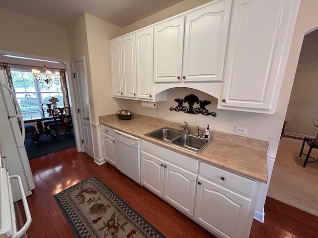 210 Petersburg Ct, Dothan, AL 36301 - kitchen with a sink, a notable chandelier, white appliances, and dark wood-style floors