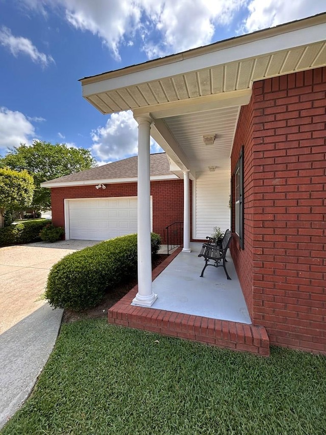 210 Petersburg Ct, Dothan, AL 36301 - view of patio featuring a porch, concrete driveway, and a garage