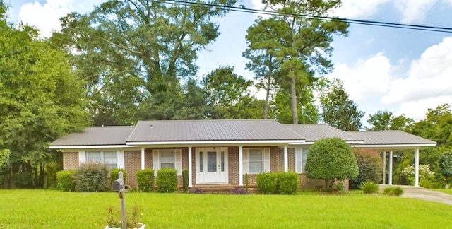 ranch-style home featuring a carport and a front yard