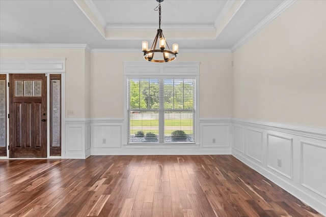 125 Hayley Dr, Enterprise, AL 36330 - unfurnished dining area featuring a chandelier, a tray ceiling, dark wood finished floors, a wainscoted wall, and ornamental molding