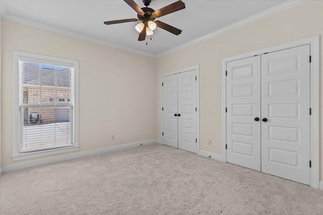125 Hayley Dr, Enterprise, AL 36330 - unfurnished bedroom featuring multiple closets, carpet flooring, ornamental molding, and ceiling fan