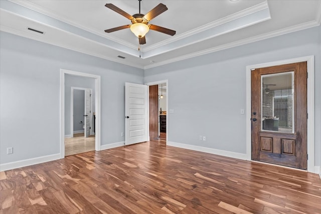125 Hayley Dr, Enterprise, AL 36330 - empty room featuring a tray ceiling, wood finished floors, a ceiling fan, and crown molding