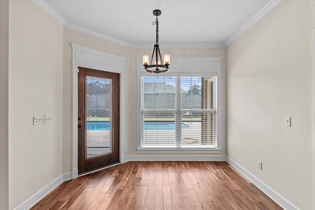 125 Hayley Dr, Enterprise, AL 36330 - unfurnished dining area featuring a chandelier, hardwood / wood-style floors, and crown molding