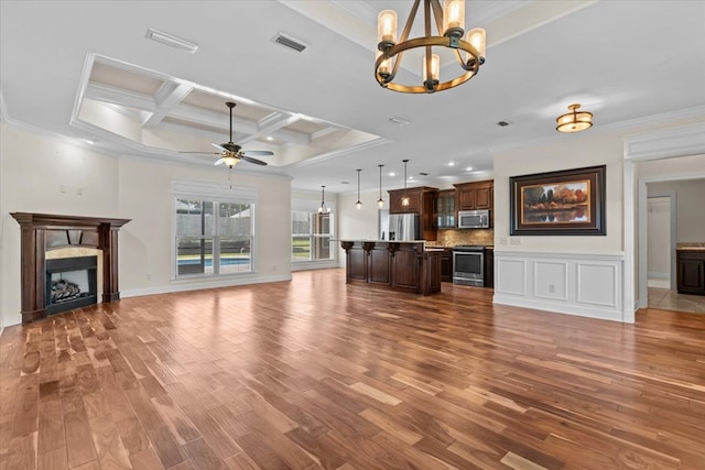 125 Hayley Dr, Enterprise, AL 36330 - unfurnished living room with ornamental molding, a chandelier, wood finished floors, a ceiling fan, and coffered ceiling