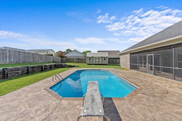 125 Hayley Dr, Enterprise, AL 36330 - view of swimming pool featuring a sunroom, a patio area, a storage unit, a fenced backyard, and a diving board
