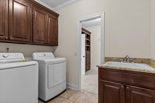 125 Hayley Dr, Enterprise, AL 36330 - laundry room featuring washing machine and clothes dryer, cabinet space, ornamental molding, light tile patterned floors, and light carpet