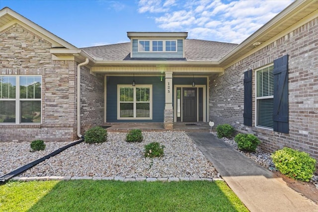 125 Hayley Dr, Enterprise, AL 36330 - doorway to property featuring a porch, roof with shingles, and brick siding