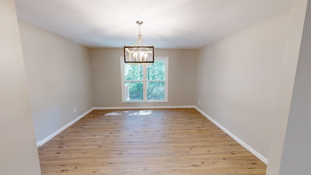 2235 Enterprise Rd, Geneva, AL 36340 - empty room with a chandelier and light hardwood / wood-style floors