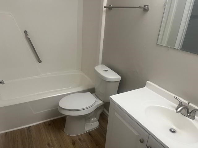 2235 Enterprise Rd, Geneva, AL 36340 - full bathroom with toilet, vanity, shower / bathtub combination, and hardwood / wood-style flooring