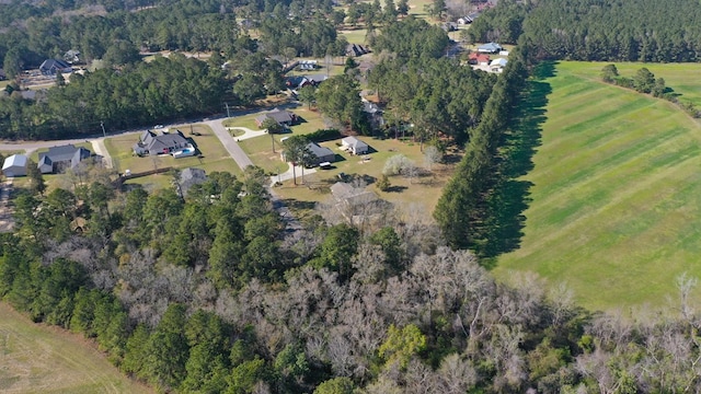 birds eye view of property featuring a wooded view