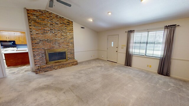 unfurnished living room with visible vents, lofted ceiling, baseboards, light colored carpet, and a brick fireplace