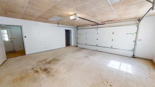 garage with a garage door opener and baseboards