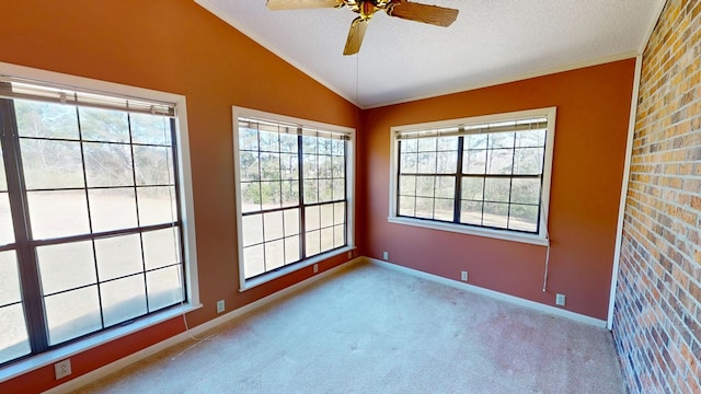 empty room with a ceiling fan, a textured ceiling, carpet floors, baseboards, and vaulted ceiling