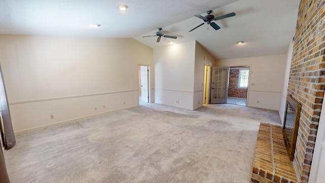 unfurnished living room featuring a brick fireplace, ceiling fan, baseboards, carpet, and lofted ceiling