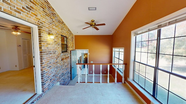 unfurnished sunroom with vaulted ceiling and a ceiling fan