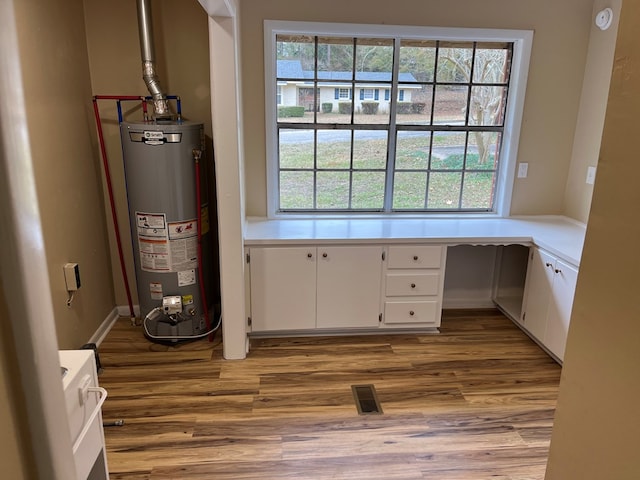 105 Martinson Dr, Abbeville, AL 36310 - unfurnished office featuring water heater, built in study area, and wood finished floors