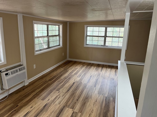 105 Martinson Dr, Abbeville, AL 36310 - empty room with wood finished floors, ornamental molding, and a wall mounted air conditioner