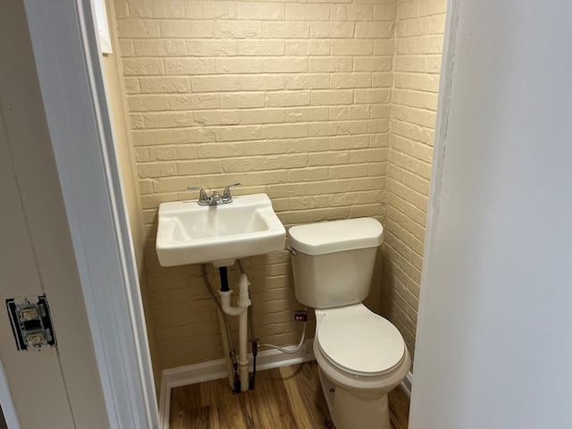 105 Martinson Dr, Abbeville, AL 36310 - half bathroom featuring wood finished floors and brick wall