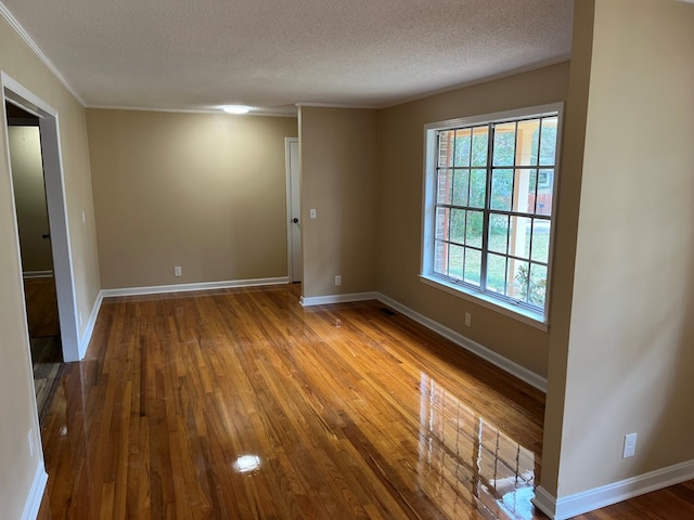 105 Martinson Dr, Abbeville, AL 36310 - unfurnished room with a textured ceiling, wood-type flooring, and crown molding