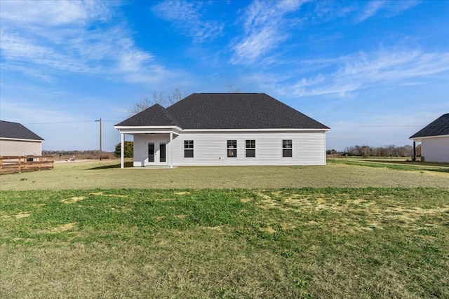 rear view of property with a lawn and french doors