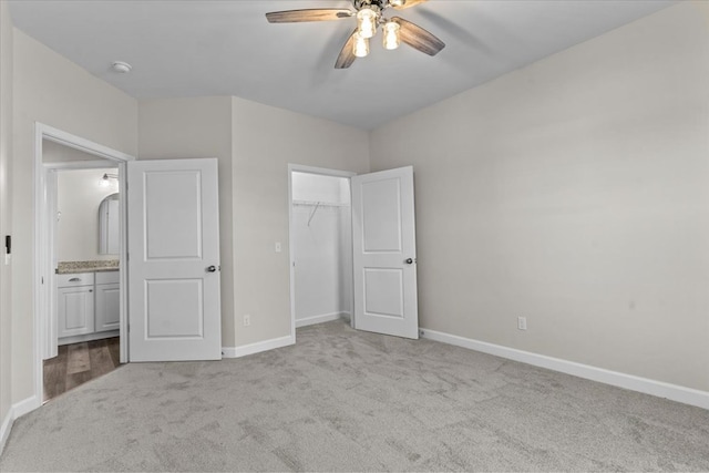 unfurnished bedroom with light carpet, ceiling fan, and a closet