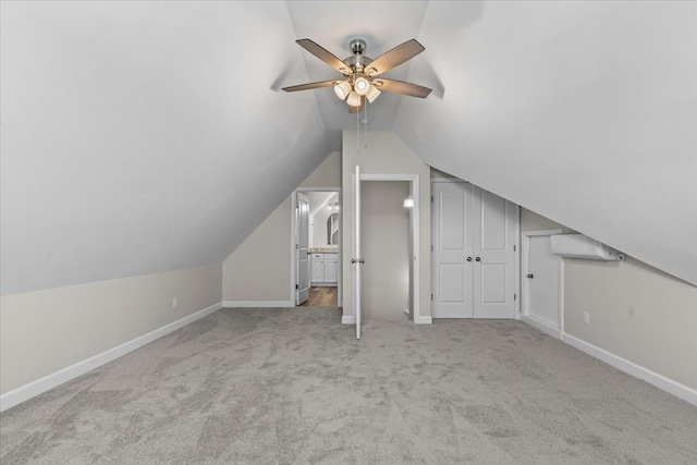 bonus room with lofted ceiling, light colored carpet, and ceiling fan