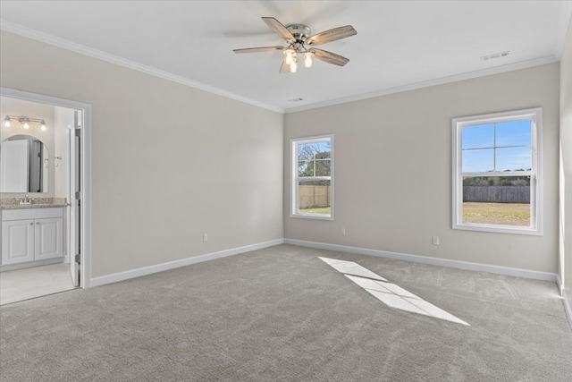 carpeted empty room with ornamental molding and ceiling fan