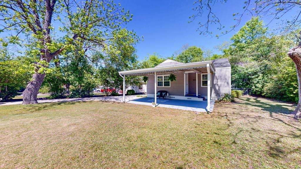 back of house featuring a yard and a patio