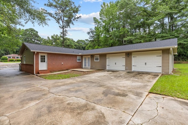 1401 Deese Rd, Ozark, AL 36360 - ranch-style home with concrete driveway, an attached garage, entry steps, and brick siding