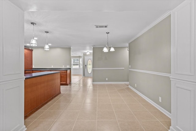1401 Deese Rd, Ozark, AL 36360 - kitchen with dark countertops, ornamental molding, a chandelier, light tile patterned flooring, and hanging light fixtures