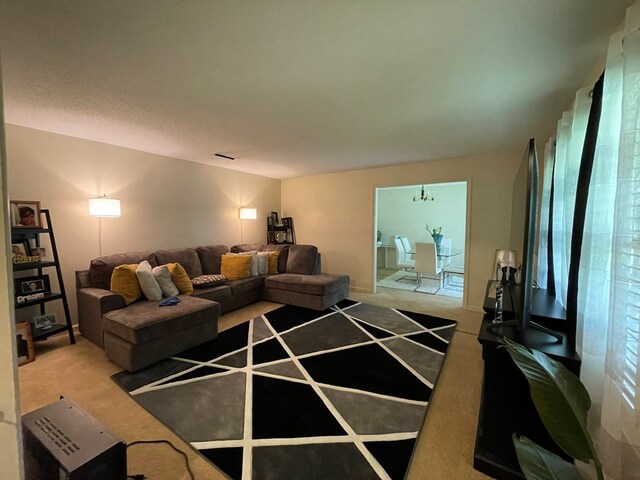 living room with a notable chandelier and carpet floors