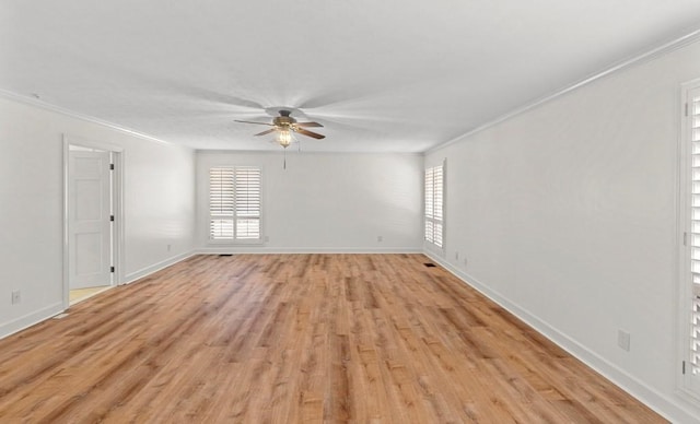 spare room with light wood-type flooring, ceiling fan, and crown molding