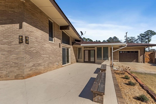 view of patio featuring french doors and a garage