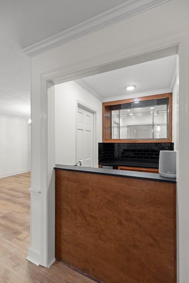 bar featuring hardwood / wood-style flooring and ornamental molding