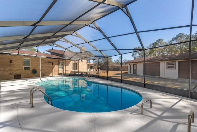 view of swimming pool with a patio and a lanai