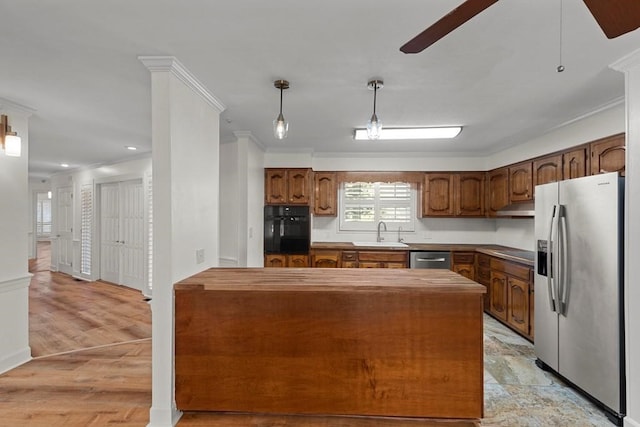 kitchen featuring appliances with stainless steel finishes, ornamental molding, and sink