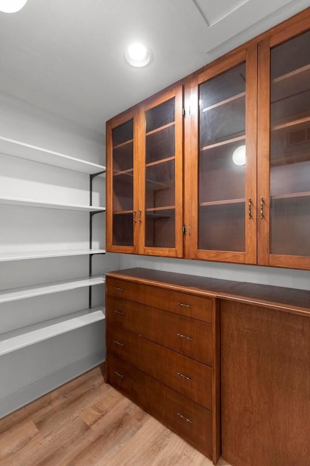 spacious closet with light hardwood / wood-style flooring