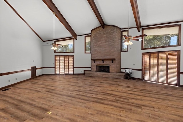 unfurnished living room featuring ceiling fan, a fireplace, high vaulted ceiling, and wood-type flooring