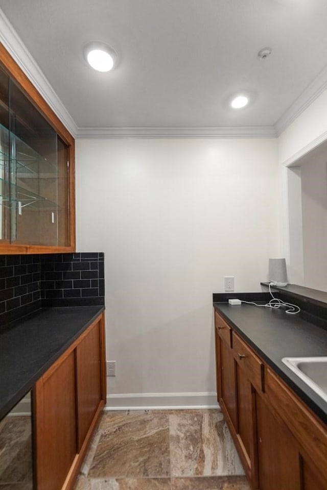 kitchen featuring decorative backsplash and crown molding