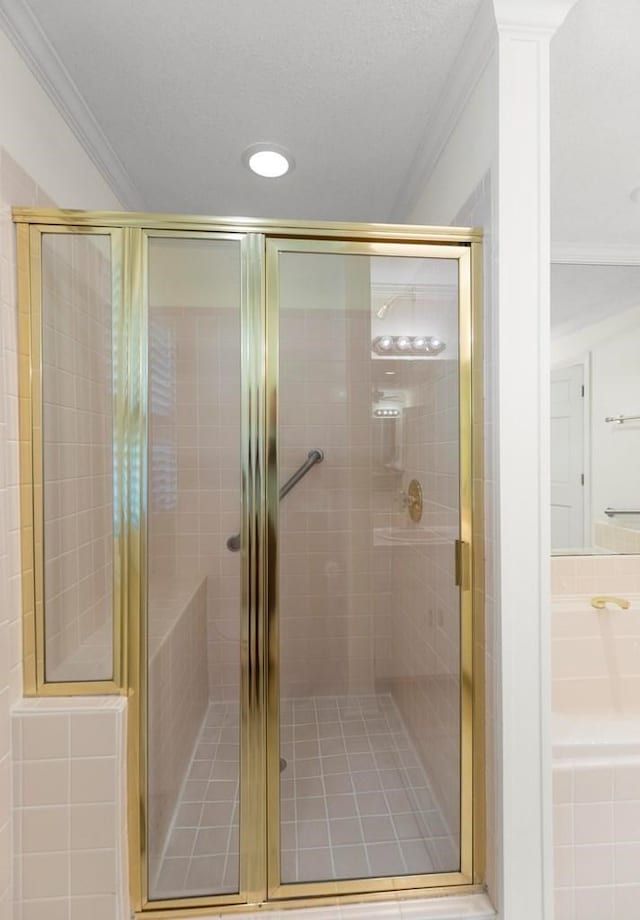 bathroom featuring a shower with door and ornamental molding