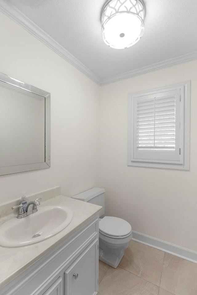 bathroom featuring tile patterned flooring, vanity, toilet, and ornamental molding