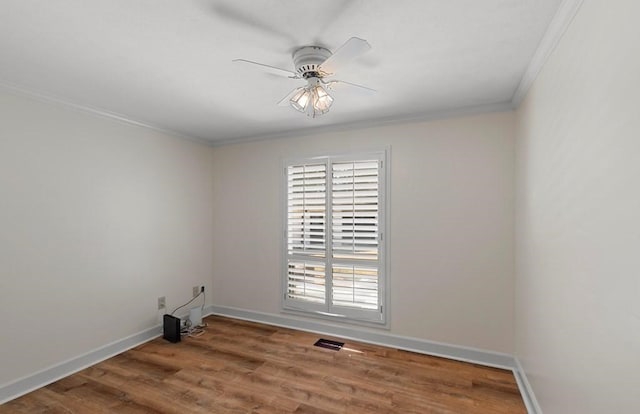 unfurnished room with hardwood / wood-style floors, ceiling fan, and crown molding