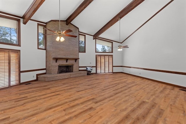 unfurnished living room featuring ceiling fan, a fireplace, and light hardwood / wood-style floors