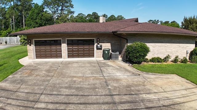 view of home's exterior with central AC unit and a yard